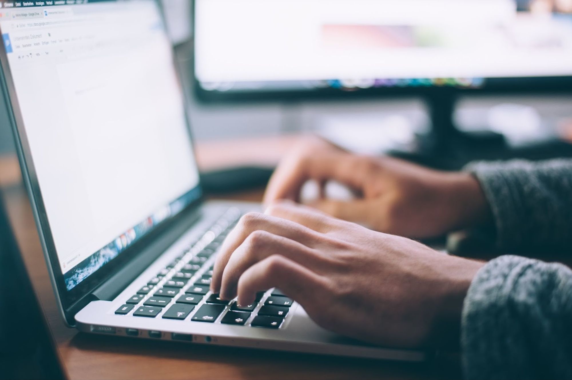 Mains tapant sur un clavier d'ordinateur